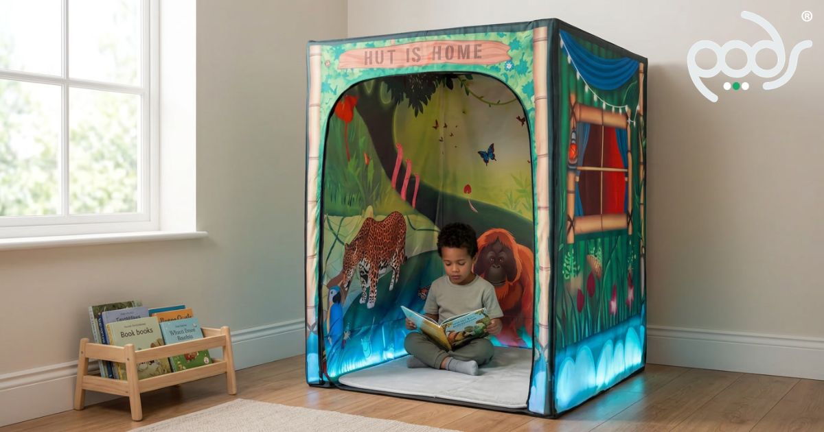 Child reading on the memory-foam mat inside a Rumble in the Jungle PODSgo reading nook.