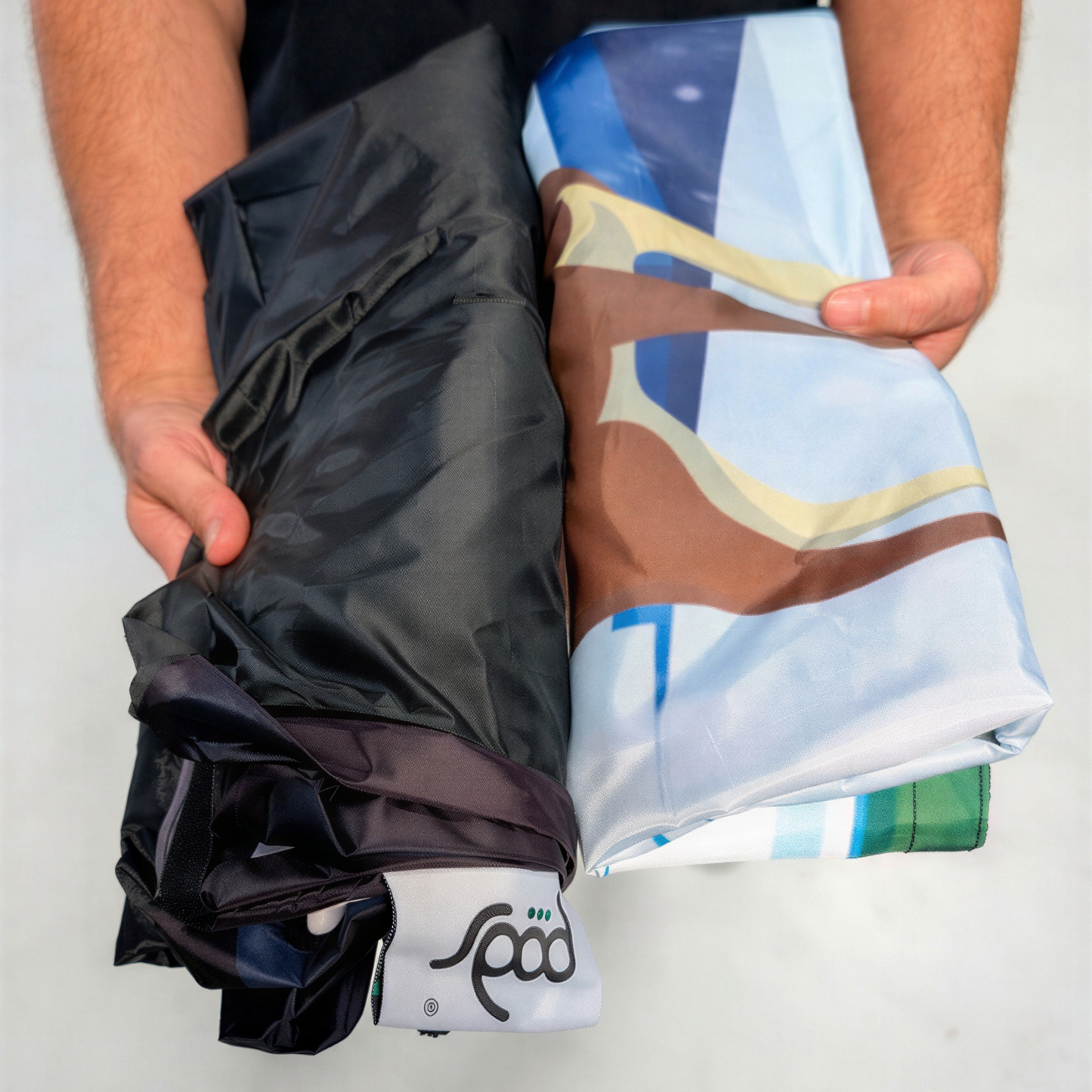 Folded PODSgo Polar Ice Igloo Adventure Jacket Set, black inner jacket beside the printed icy arctic outer jacket