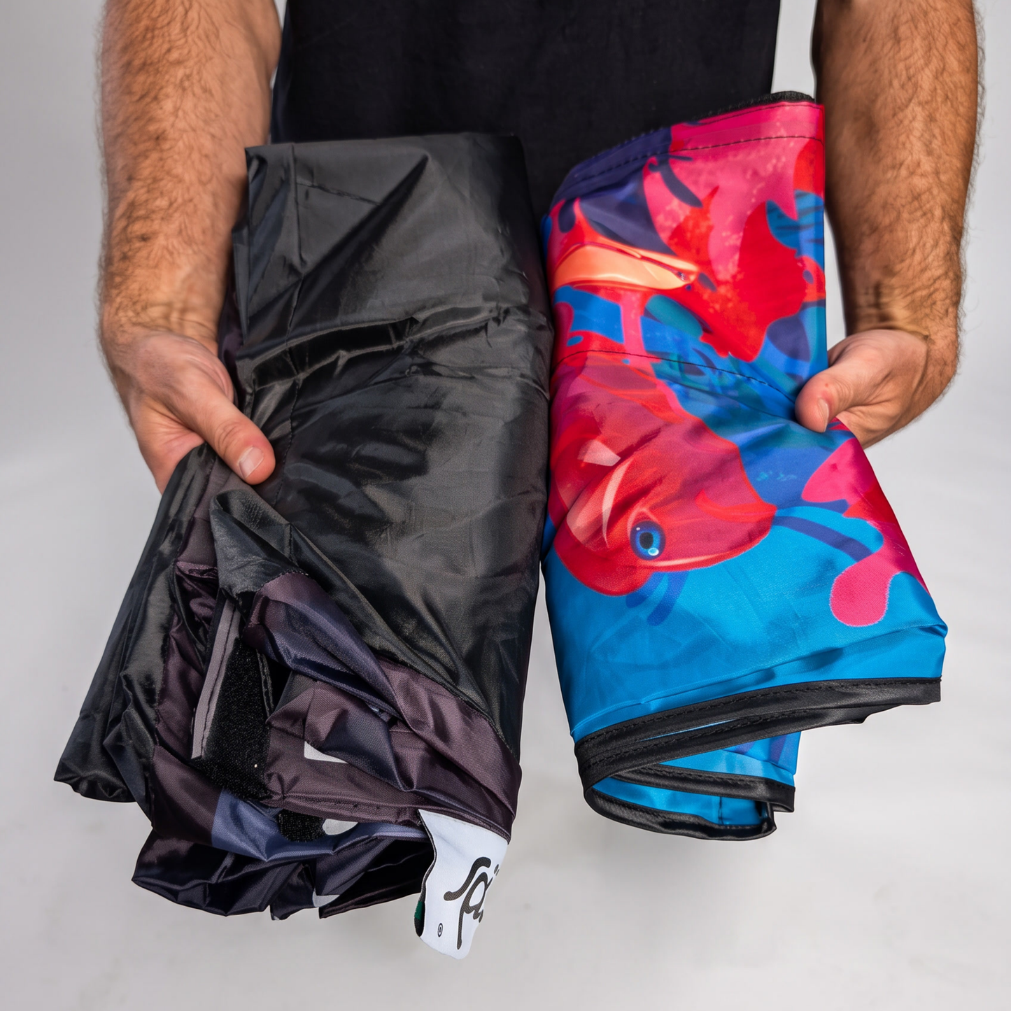 Folded PODSgo Sub Aqua Quest Adventure Jacket Set, black inner jacket beside the printed blue ocean and fish outer jacket